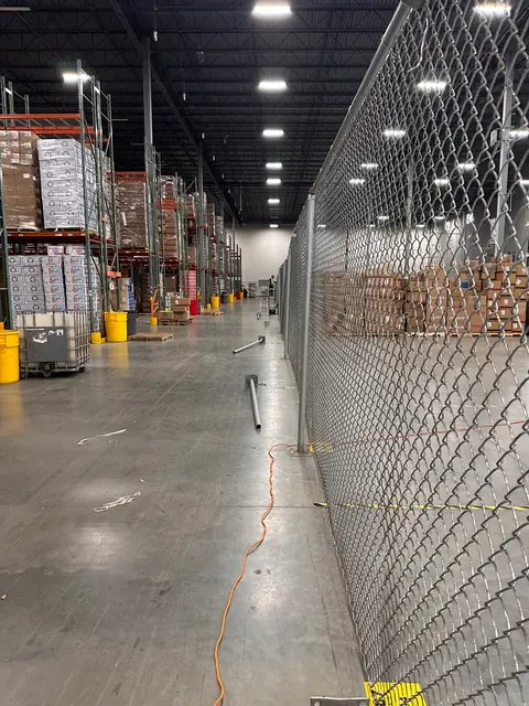 Tall chain link partition in a distribution warehouse.